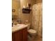 Well-lit bathroom with a floral shower curtain, decor, and ample counter space at 227 Two Oaks Dr, Edgewater, FL 32141
