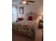 Comfortable bedroom with a floral patterned quilt and decorative headboard and accents at 227 Two Oaks Dr, Edgewater, FL 32141