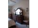Bedroom with a large dresser, decorative mirror, and candle sconces at 227 Two Oaks Dr, Edgewater, FL 32141