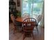 Cozy dining area with wood table, four chairs, and sliding glass doors to the outside at 227 Two Oaks Dr, Edgewater, FL 32141