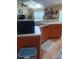 Bright kitchen with stainless steel sink, oak cabinetry, breakfast bar, and adjacent living area at 227 Two Oaks Dr, Edgewater, FL 32141