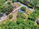 An aerial shot highlights a home with a big yard shaded by mature trees at 242 Cypress Ave, Oak Hill, FL 32759
