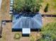 Overhead view of a single-Gathering home featuring a large backyard, mature trees, and a long driveway at 242 Cypress Ave, Oak Hill, FL 32759