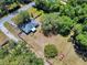 Aerial view of property with a large lot, mature trees, a fenced yard, and a driveway for ample parking at 242 Cypress Ave, Oak Hill, FL 32759