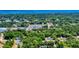This aerial captures a serene neighborhood by the water, surrounded by green spaces and a close-knit community at 242 Cypress Ave, Oak Hill, FL 32759
