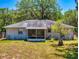 Spacious backyard featuring a single-Gathering home with screened-in patio at 242 Cypress Ave, Oak Hill, FL 32759