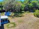 Large backyard featuring lush trees, a shed, and plenty of space for recreation and relaxation at 242 Cypress Ave, Oak Hill, FL 32759