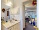 Bright bathroom features a vanity with storage and a decorative mirror, offering a blend of functionality and style at 242 Cypress Ave, Oak Hill, FL 32759