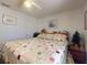 This inviting bedroom features a patchwork quilt and a ceiling fan, creating a cozy and comfortable space at 242 Cypress Ave, Oak Hill, FL 32759