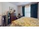 This bedroom boasts a dresser, a floral-patterned bed, and green curtains for a comfortable, restful space at 242 Cypress Ave, Oak Hill, FL 32759