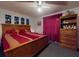 Bedroom features a large bed, ceiling fan, and a dresser at 242 Cypress Ave, Oak Hill, FL 32759