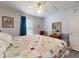 Relaxing bedroom features a patchwork quilt, ceiling fan, and natural light for a serene and inviting space at 242 Cypress Ave, Oak Hill, FL 32759