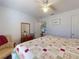 Inviting bedroom features a patchwork quilt and natural light, offering a cozy and comfortable retreat at 242 Cypress Ave, Oak Hill, FL 32759