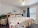 Charming bedroom with a patchwork quilt, ceiling fan, and window, offering a cozy and inviting space to relax at 242 Cypress Ave, Oak Hill, FL 32759