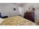 Relaxing bedroom showcases a floral-patterned bed and a dresser, providing a cozy and well-furnished space at 242 Cypress Ave, Oak Hill, FL 32759