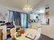 Dining area with a round table, seating, and view into the adjacent kitchen at 242 Cypress Ave, Oak Hill, FL 32759
