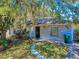 Charming single-Gathering home with a brick facade and a well-maintained front yard with a curved walkway at 242 Cypress Ave, Oak Hill, FL 32759