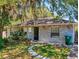 Charming one-story home with a well-manicured lawn, quaint stepping stones, and a brick facade at 242 Cypress Ave, Oak Hill, FL 32759