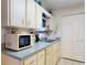 Bright kitchen with ample counter space and white cabinetry at 242 Cypress Ave, Oak Hill, FL 32759
