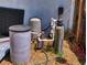 Water filtration system components behind the house featuring tanks, pumps, and filters at 242 Cypress Ave, Oak Hill, FL 32759