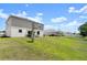 Spacious backyard featuring a well-maintained lawn, partial fence, and a patio area, perfect for outdoor activities at 2516 Hoptree Ln, Edgewater, FL 32141