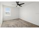 Bedroom with neutral carpet, ceiling fan and a bright window view at 2516 Hoptree Ln, Edgewater, FL 32141