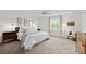 Bright bedroom features neutral paint, carpeting, and a large window, creating peaceful retreat at 2516 Hoptree Ln, Edgewater, FL 32141