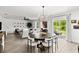 Bright dining area with an open floorplan, modern chandelier, and sliding glass doors to the outdoor area at 2516 Hoptree Ln, Edgewater, FL 32141