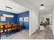 Beautiful dining room featuring a large wooden table, elegant chandelier, and stylish blue accent wall at 2516 Hoptree Ln, Edgewater, FL 32141