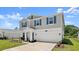 Charming two-story home featuring blue shutters, a manicured lawn, and a two-car garage at 2516 Hoptree Ln, Edgewater, FL 32141