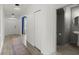 Hallway with wood-look tile flooring leading to a dining room and a conveniently located powder room at 2516 Hoptree Ln, Edgewater, FL 32141