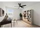 Stylized home office with desk, chair, bookshelf, and ceiling fan at 2516 Hoptree Ln, Edgewater, FL 32141