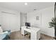 Modern home office with a white desk, neutral carpet, and ample lighting at 2516 Hoptree Ln, Edgewater, FL 32141