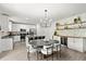 Modern kitchen featuring stainless appliances, white cabinets, bar seating, and beverage bar with wooden shelves at 2516 Hoptree Ln, Edgewater, FL 32141