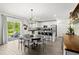 Open concept kitchen with white cabinetry, an island with barstool seating, and sliding glass doors to the outside at 2516 Hoptree Ln, Edgewater, FL 32141