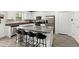 Modern kitchen features stainless appliances, white cabinets and drawers, gray countertops, and bar stool seating at 2516 Hoptree Ln, Edgewater, FL 32141