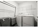 Functional laundry room with washer, dryer, and storage solutions at 2516 Hoptree Ln, Edgewater, FL 32141