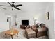 Cozy living room with plush armchair, ottoman, and modern ceiling fan creates a comfortable space at 2516 Hoptree Ln, Edgewater, FL 32141