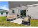Cozy outdoor patio with cushioned seating, perfect for relaxing or entertaining with sliding glass door to inside at 2516 Hoptree Ln, Edgewater, FL 32141