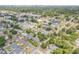 An aerial view highlighting a charming home with a refreshing private pool nestled within a tranquil, tree-lined neighborhood at 2548 E Compton St, Orlando, FL 32806