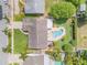 Aerial view showcases a house with a large backyard, including a beautiful pool, spa, and meticulously maintained landscaping at 2548 E Compton St, Orlando, FL 32806