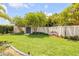 Well-maintained backyard with a storage shed, lush lawn, manicured landscaping, and a privacy fence for a serene outdoor space at 2548 E Compton St, Orlando, FL 32806