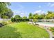Beautiful backyard showcases a well-maintained lawn, vibrant landscaping, and a relaxing pool area, great for entertainment at 2548 E Compton St, Orlando, FL 32806