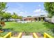 Expansive backyard featuring a pristine pool, lush landscaping, and a charming shed, perfect for outdoor living at 2548 E Compton St, Orlando, FL 32806