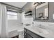 Bright bathroom with a white vanity, updated fixtures, and a shower-tub combination at 2548 E Compton St, Orlando, FL 32806