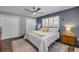 Bright bedroom with plantation shutters, wood floors, ceiling fan and neutral decor at 2548 E Compton St, Orlando, FL 32806