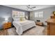 Light filled bedroom with shuttered windows, ceiling fan, and a comfortable king-sized bed at 2548 E Compton St, Orlando, FL 32806