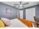 Spacious bedroom featuring wood floors, closet space, and a ceiling fan at 2548 E Compton St, Orlando, FL 32806