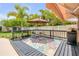 Outdoor deck with a colorful rug, dining set, barbecue grill, and a retractable awning for comfortable outdoor living at 2548 E Compton St, Orlando, FL 32806