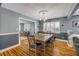 Dining room with hardwood floors, a modern light fixture, and shuttered windows at 2548 E Compton St, Orlando, FL 32806